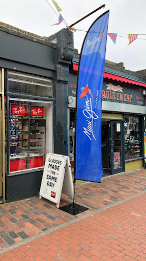 "Specs shopfront with blue flag and 'Glasses Made The Same Day' sign."